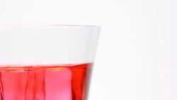 half of rotation: ice in top of red water glass Stock Footage