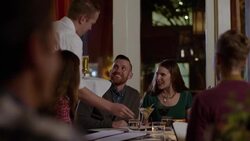 Waiter delivers cocktails and beer to dining party at upscale restaurant Stock Footage