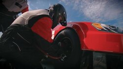 Stock car pit-crewman removes race-car lug-nuts Stock Footage