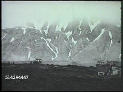1943: ALEUTIAN ISLANDS CAMPAIGN: ATTU INVASION:  VS United States Army artillery regiment firing into hills of Massacre Valley, Marines firing mortar & artillery cannons, soldiers advancing up snow covered mountain. WWII, Pacific Front, Alaska Instructional Video