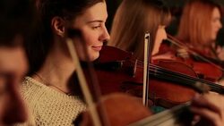 Violinists smiling in orchestra Stock Footage