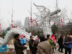 MS PAN Dragon shaped lanterns celebrate for spring festival with porcelain dishes at small wild goose pagoda park / xi'an, shaanxi, china Stock Footage