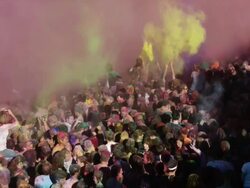 crowd of people at a Hindu festival throwing colored powder into the air Stock Footage