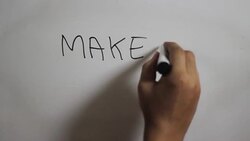 Hand writing a 'Make it happen'on white board Stock Footage