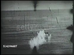 1943: ALEUTIAN ISLANDS CAMPAIGN: PARAMUSHIRO BOMBINGS: VS Various Consolidated B-24 Liberator bomber aircrafts flying, POV firing on Imperial Japanese Navy ships at sea near Paramushiro (Kuril Islands), firing on targets at sea. WWII, Pacific Front Instructional Video