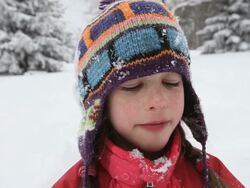 CU Girl smiling and eating snow during snow storm / Yarmouth, Maine, USA Stock Footage