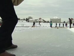 Nymphenburg, curling stick slips over ice, legs of a man, people in background Stock Footage