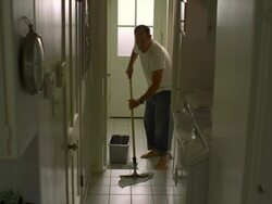 WS, Man mopping tile floor in laundry room, Hollywood, California, USA Stock Footage