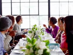 MS group of friends sitting at dinner party in loft eating dinner Stock Footage