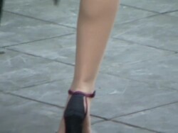 A man and woman dance together near a red and yellow building in Buenos Aires. Stock Footage