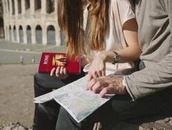 Tourists with guide and map in front of the Coliseum Stock Footage
