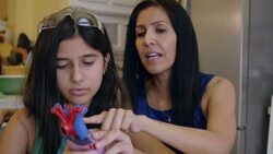 Mature woman teaching preteen daughter during home school science class Stock Footage