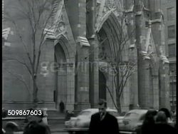1948: NEW YORK CITY: ST PATRICK'S CATHEDRAL: WS (POV across street) EXT St Patrick's Cathedral w/ traffic moving downtown on 5th Avenue, people walking sidewalk FG.   Roman Catholic Archdiocese, parish church, religion, Freedom of Worship. Instructional Video