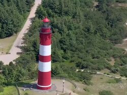 WS AERIAL ZO Tractor working in field near sea shore / FoehrAmrum, Schleswig-Holstein, Germany Stock Footage
