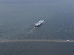 WS AERIAL ZI TS View of Great belt bridge with ship / Fyn, Denmark Stock Footage