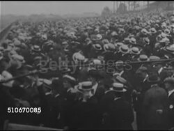 1920s: HORSE RACING: HA XWS Crowd at unidentified race track. WS Thoroughbred race horse Man O' War standing on track w/ jockey in saddle. PAN Crowd. VS Horses racing, Man O' War running alone. MS Jockey & trainer Earl H. Sande. Instructional Video