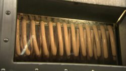 Plastic wraps frankfurter links in a packing plant. Stock Footage