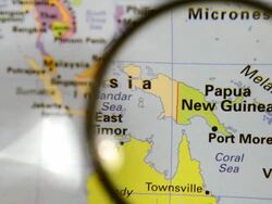 Magnifying glass over Papua New Guinea map Stock Footage