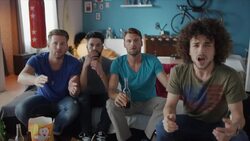 Guys sitting on couch watching tv disappointed Stock Footage