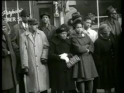 B/W 1960's crowd of black people standing on sidewalk / SOUND Stock Footage