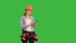 Beautiful young woman construction worker working on tablet Stock Footage