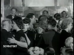 1948: NEW YORK CITY: Crowded sidewalk (possibly Times Square) people in coats. NIGHTCLUB: People in upscale club dancing on crowded dance floor, band BG. Girl tap dancing near tables. Two couples at small table being served cocktails. Nightlife. Instructional Video