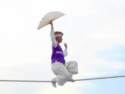 MS PAN Shot of tightrope walker doing acrobatics on high wire / Gyeonggido, South Korea Stock Footage