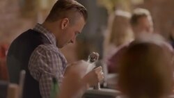 Busy bartenders mix drinks at crowded bar Stock Footage