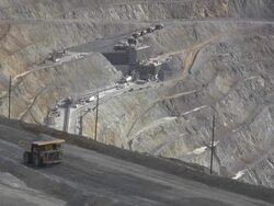 Large dump truck hauling iron ore in a mine Stock Footage