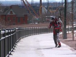 A man uses a jetpack to fly over a park. Stock Footage