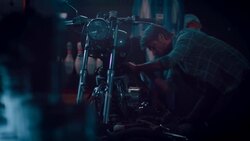 Man in motorcycle workshop building a bike Stock Footage