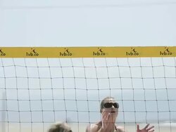 CU of female beach volleyball players spiking and blocking at the net. Stock Footage
