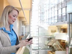 MS Well dressed business woman using and talking on cellular device inside office building during day / Minneapolis, Minnesota, United States Stock Footage