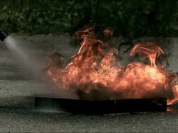 High speed water fire extinguisher, putting out fire Stock Footage