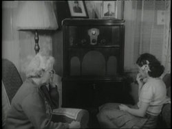 Concerned families listen to news about the war on radios during World War II. Stock Footage