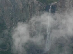 Closeup of Bridalveil Fall with dramatic, swirling winter storm clouds, Yosemite Valley in Yosemite National Park, California Stock Footage