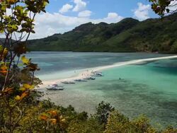 "PAN of outrigger boats anchored along idyllic sandbar / Snake Island, Bacuit Archipelago, El Nido, Palawan, Philippines" Stock Footage