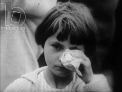Building of the Berlin Wall in 1961. Relatives wave at each other across the wall and barbed wire. Stock Footage