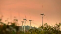 Modern wind-powered turbines rotate in the Honduran countryside Stock Footage