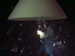 SLOMO CU light bulb under shade exploding Stock Footage