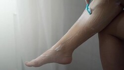 Woman shaving legs under shower. Stock Footage