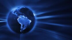 A radiant blue earth spins against a streaked blue background. Stock Footage