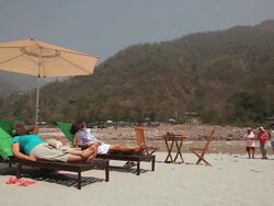 Five senior people enjoying at riverbank, Ganges River, Rishikesh, Uttarakhand, India Stock Footage