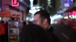 Young couple walk arm-in-arm down busy streets and sidewalks towards the heart of Times Square Stock Footage