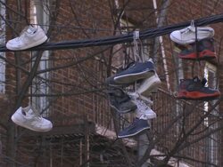 Shoes dangling from power lines in the Bronx during the day Stock Footage