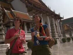 MS DS. Young couple at Wat Phra Kaew (Temple of the Emerald Buddha), Bangkok, Thailand Stock Footage