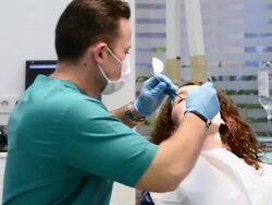 DOLLY: Young woman in dentist office Stock Footage