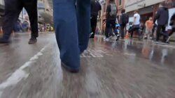 People walk through the crowded streets of Austin in the rain during South By Southwest Stock Footage