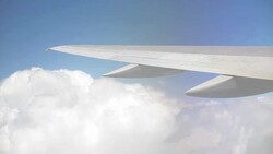 Plane Flying Atop Clouds Stock Footage