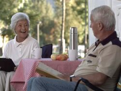 HD Super Slow-Mo: Seniors Having Fun Reading At Campsite Stock Footage